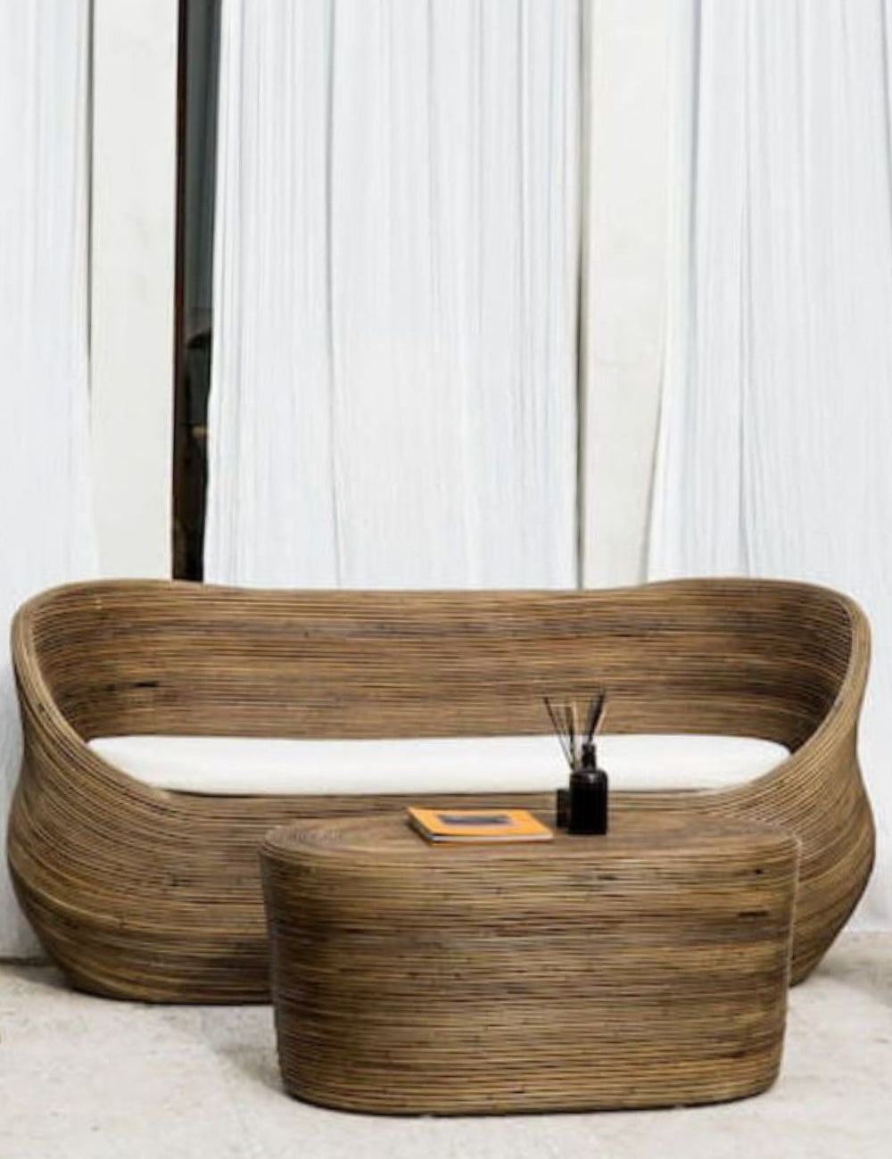 Handmade brown round rattan sofa Tegal with ecru cushions, designed for eco-friendly outdoor living on patios and terraces