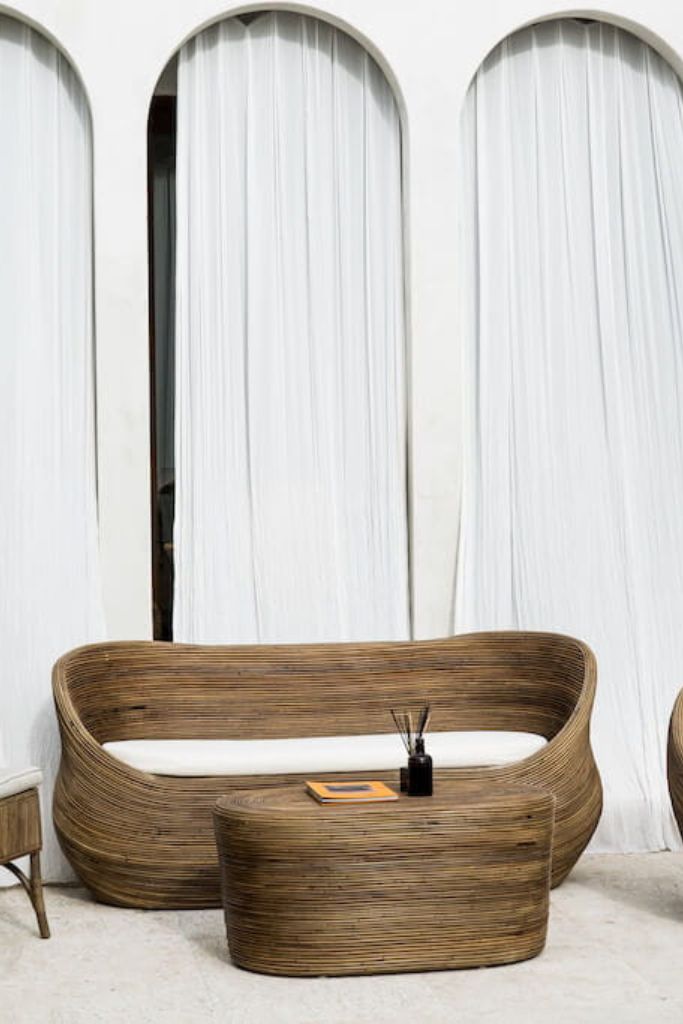 Handmade brown round rattan sofa Tegal with ecru cushions, designed for eco-friendly outdoor living on patios and terraces