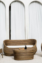 Handmade brown round rattan sofa Tegal with ecru cushions, designed for eco-friendly outdoor living on patios and terraces