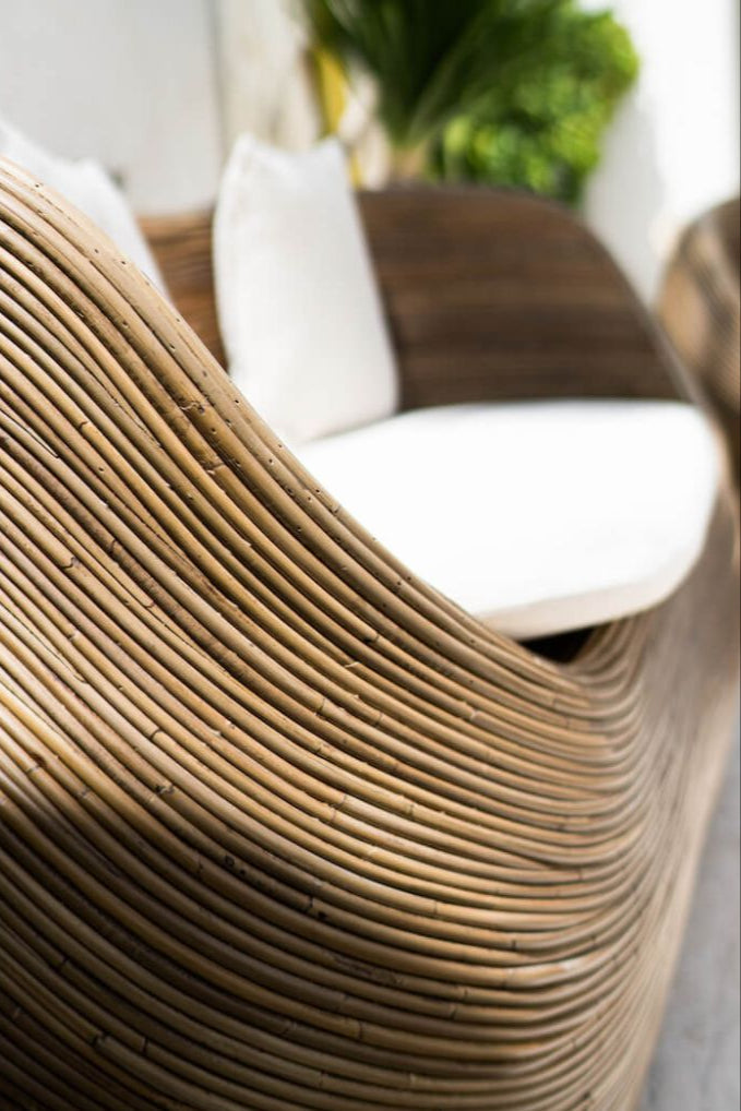 Handmade brown round rattan sofa Tegal with ecru cushions, designed for eco-friendly outdoor living on patios and terraces