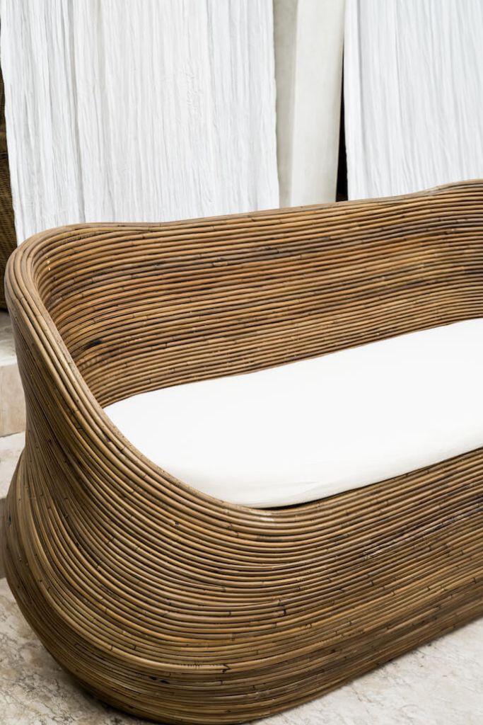 Handmade brown round rattan sofa Tegal with ecru cushions, designed for eco-friendly outdoor living on patios and terraces