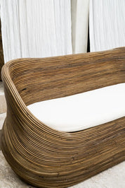 Handmade brown round rattan sofa Tegal with ecru cushions, designed for eco-friendly outdoor living on patios and terraces