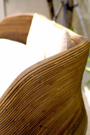 Handmade brown round rattan sofa Tegal with ecru cushions, designed for eco-friendly outdoor living on patios and terraces