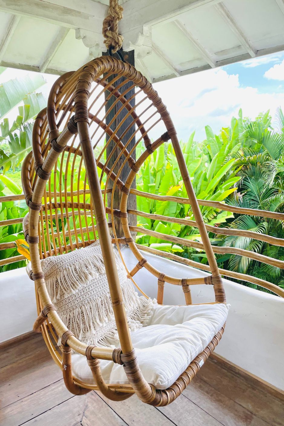Durable handmade natural rattan hanging swing chair single, designed for relaxing indoor or outdoor comfort.