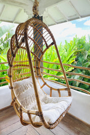 Durable handmade natural rattan hanging swing chair single, designed for relaxing indoor or outdoor comfort.