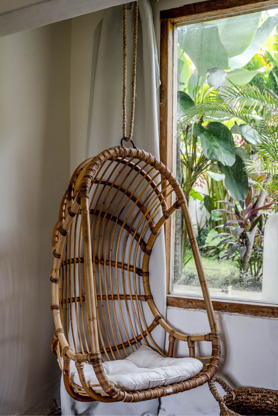 Durable handmade natural rattan hanging swing chair single, designed for relaxing indoor or outdoor comfort.