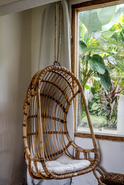 Durable handmade natural rattan hanging swing chair single, designed for relaxing indoor or outdoor comfort.