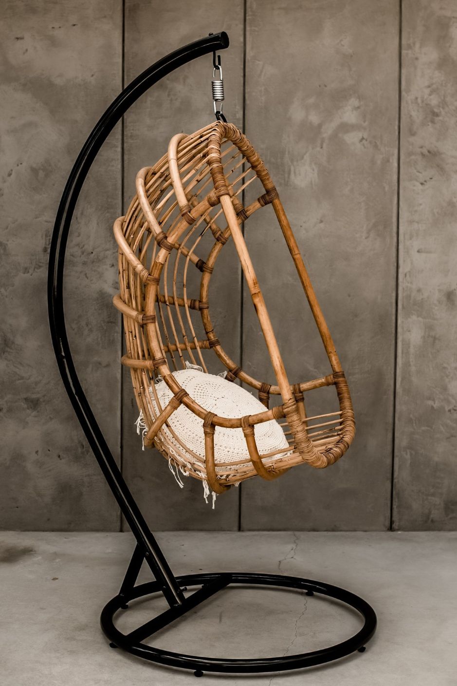 Durable handmade natural rattan hanging swing chair single, designed for relaxing indoor or outdoor comfort.