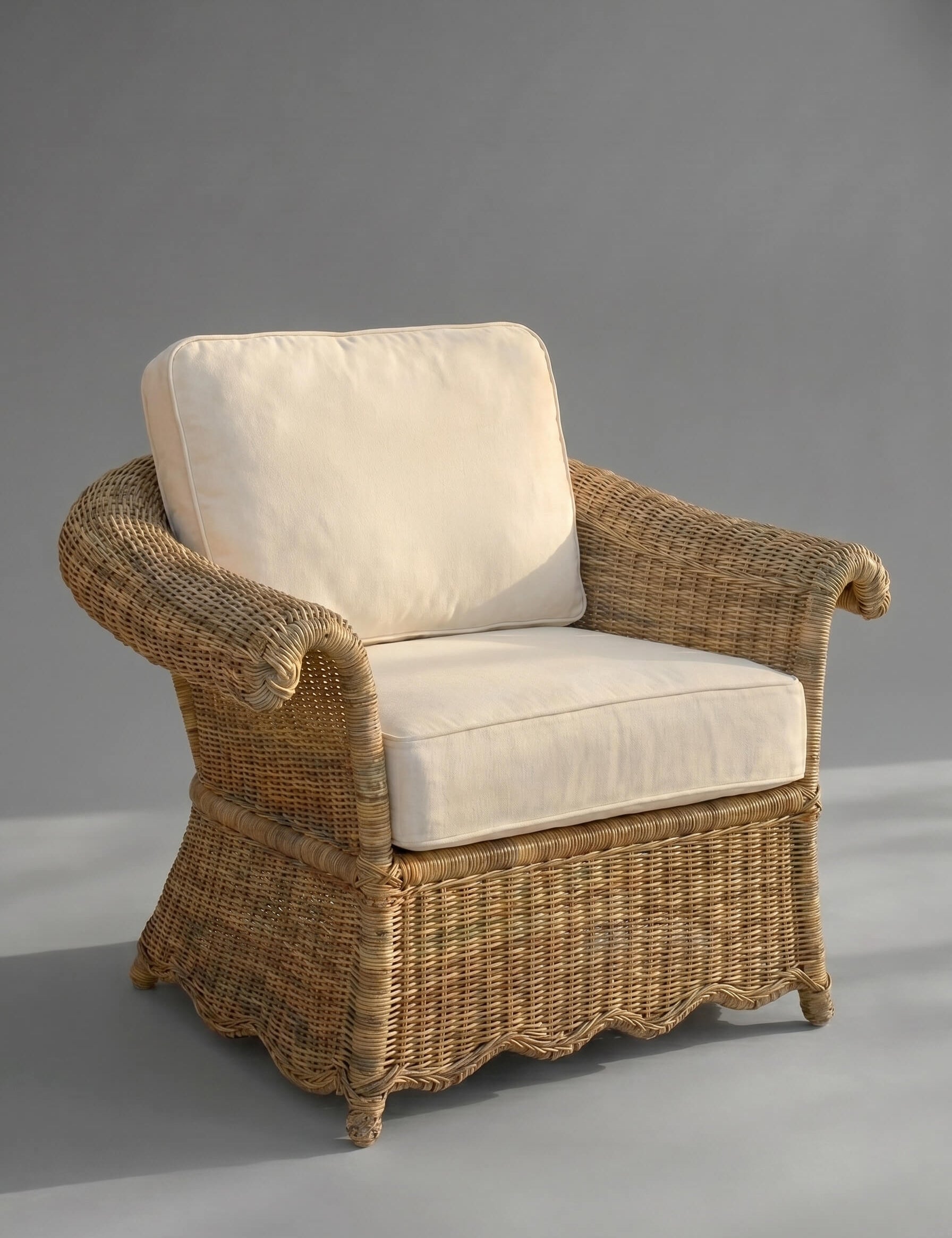 Wicker armchair with white cushions on a gray background