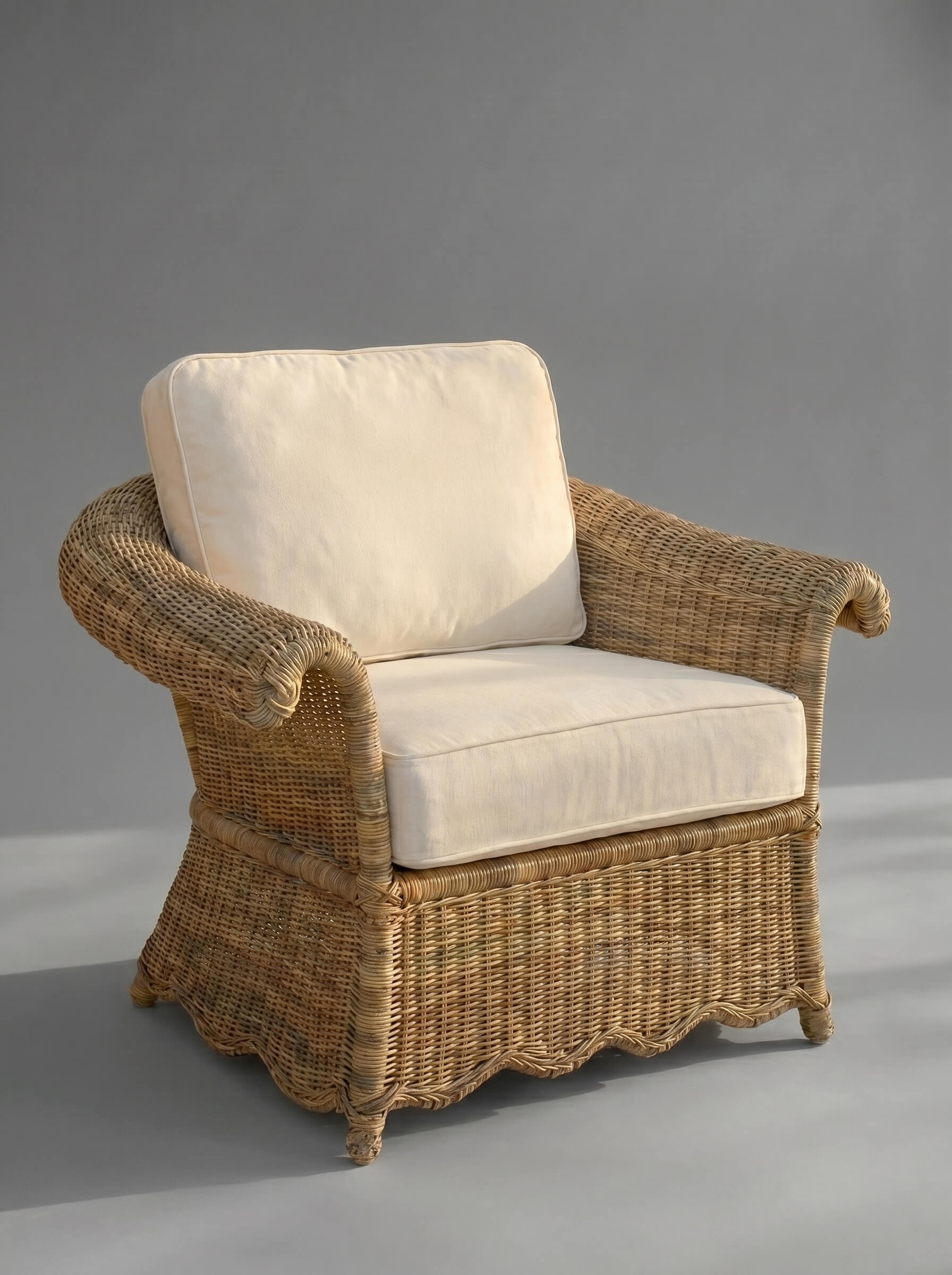 Wicker armchair with white cushions on a gray background