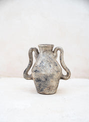 Vintage ceramic vase with handles on a white background