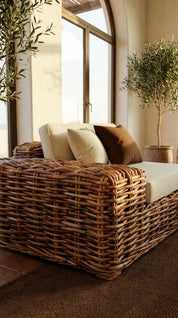 Woven rattan armchair with natural finish