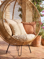 Rattanround chair styled beside lounge chair
Handcrafted rattan chair with woven texture