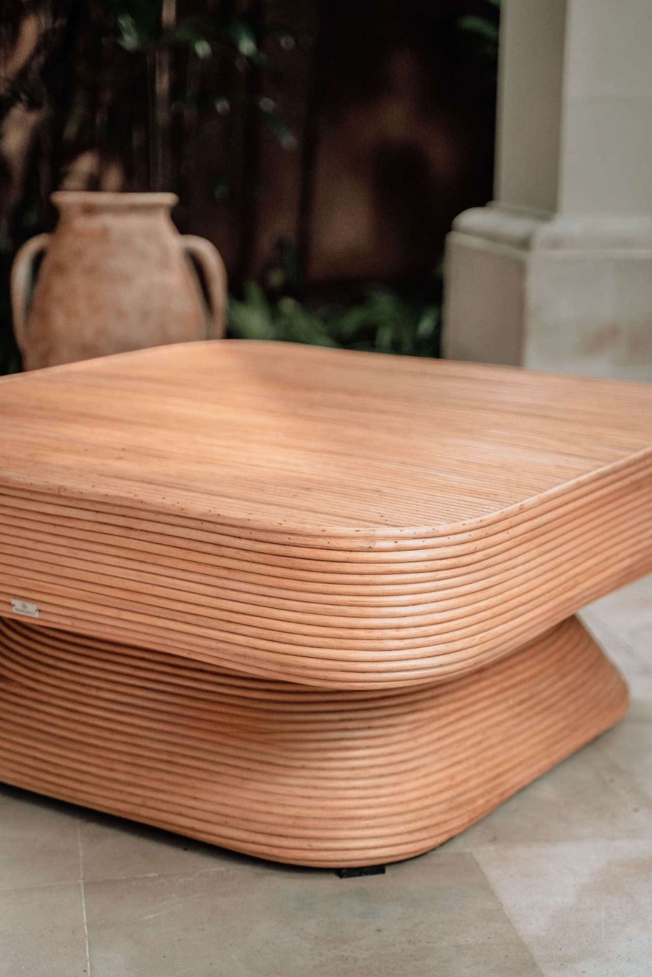 Coastal style natural rattan table Tegal Carla Square with tilted pedestal, handmade artisan furniture for living room, swimming pool or lounge spaces.