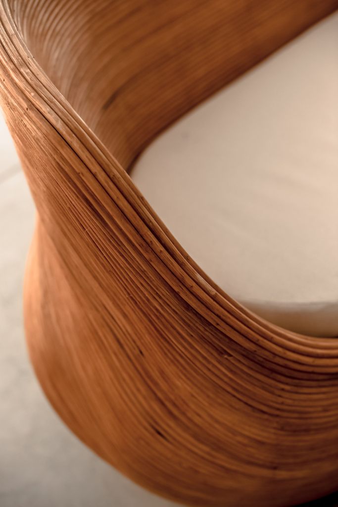 Handmade cognac round rattan sofa Tegal with ecru cushions, designed for eco-friendly outdoor living on patios and terraces