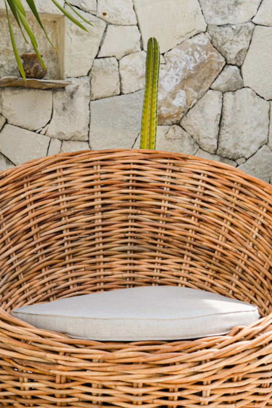 Ingka Halo cognac handmade rattan sofa lounge chair with thick weave, modern minimalist design for living rooms and lounges.