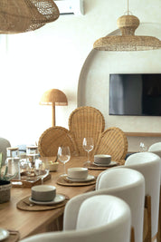 Natural rattan armchair with minimalist aesthetic
