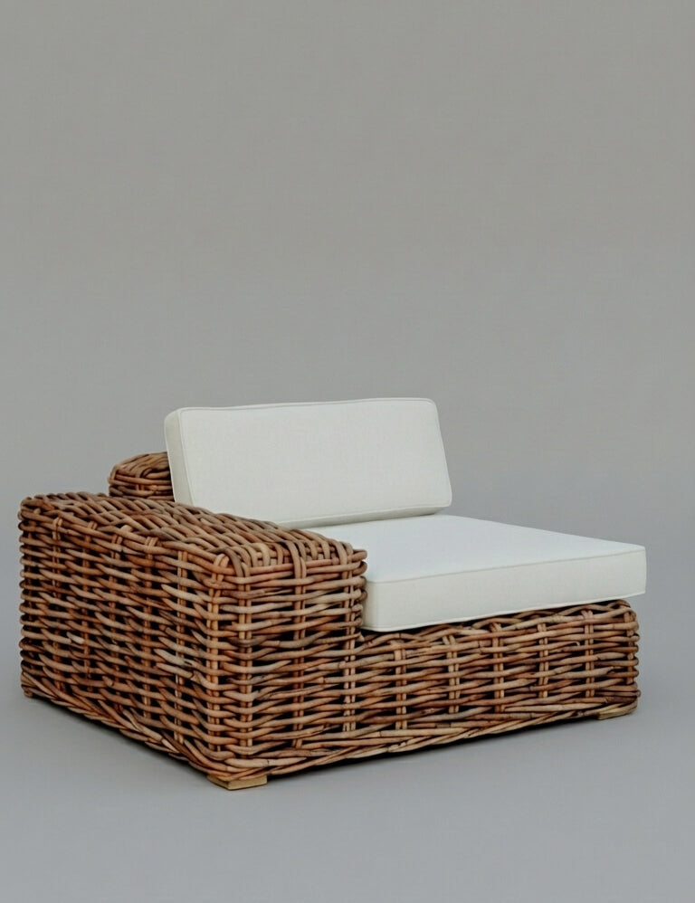 Wicker outdoor chair with white cushion on a gray background