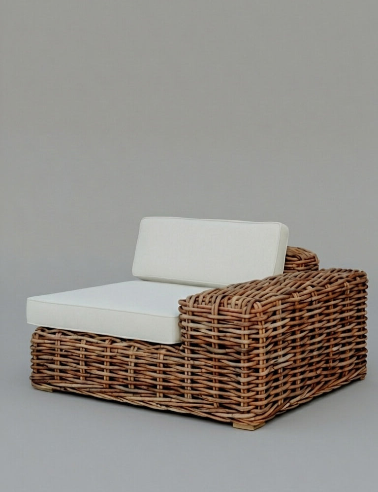 Wicker outdoor chair with white cushion on a gray background