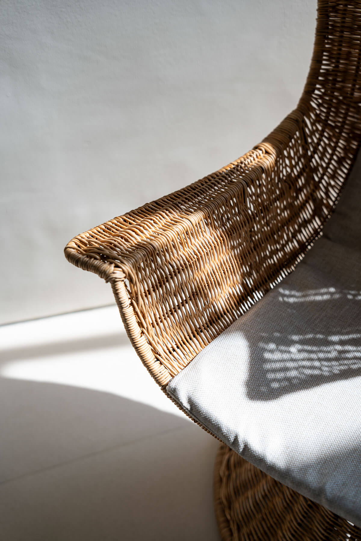 Rattan lounge chair with woven backrest detail
