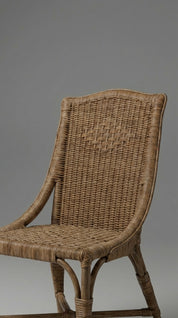 Woven wicker chair against a gray background