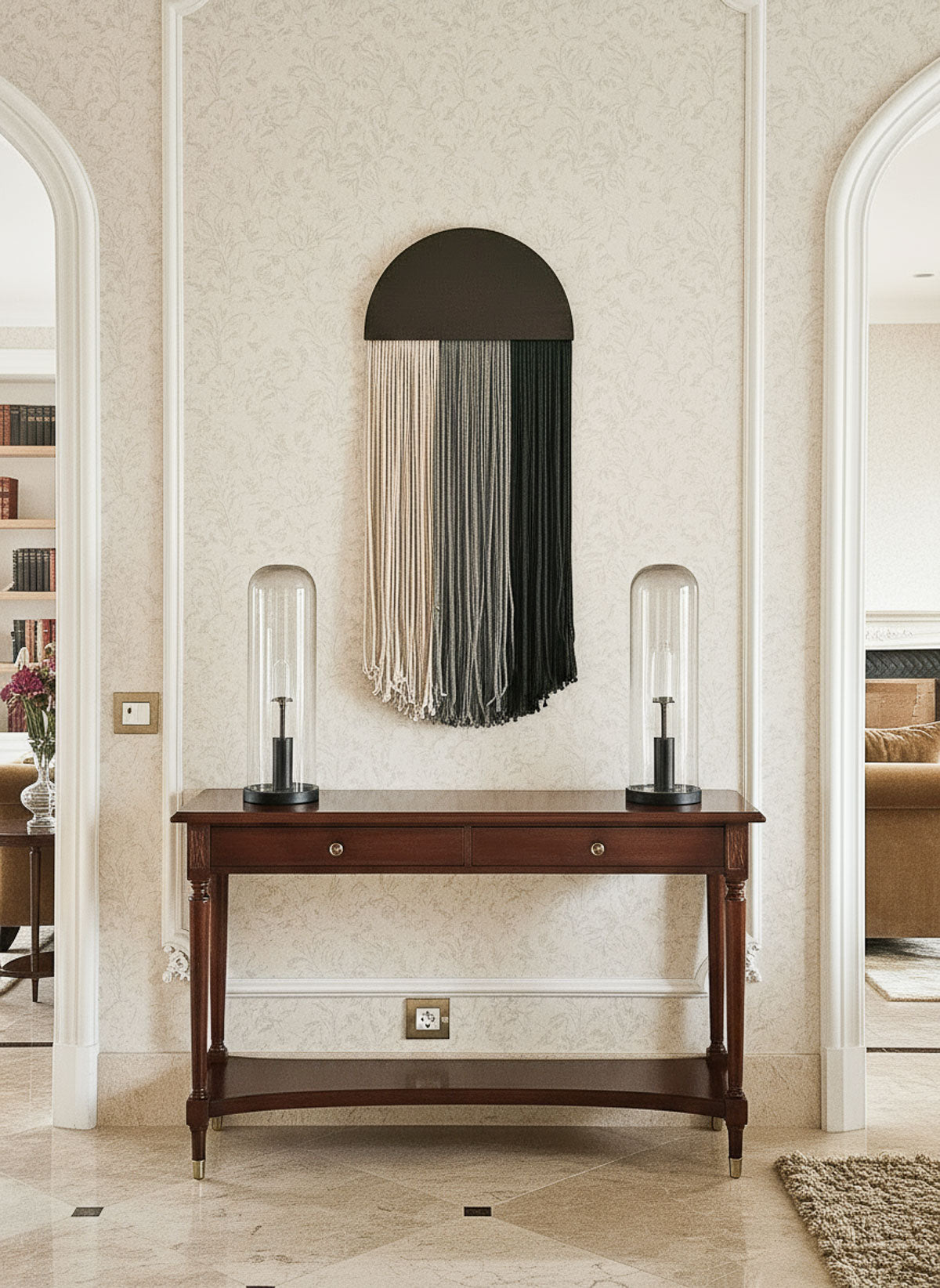 Decorative console table with a mirror and lamps in an elegant room.