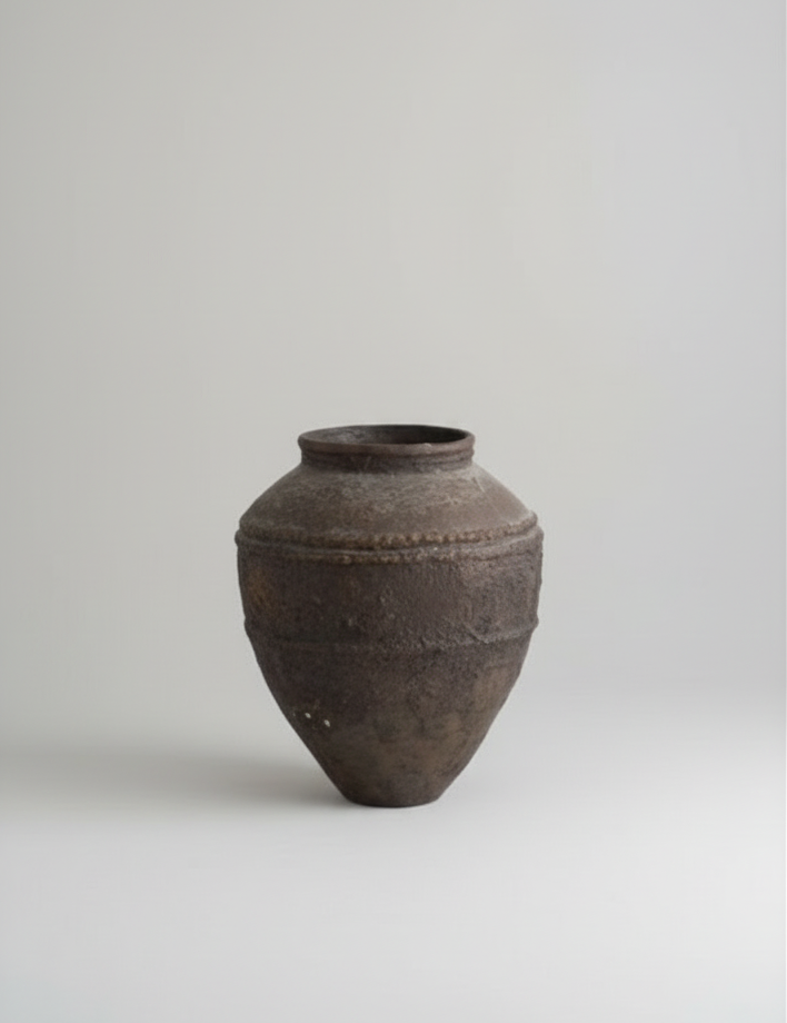 Brown ceramic vase on a light gray background