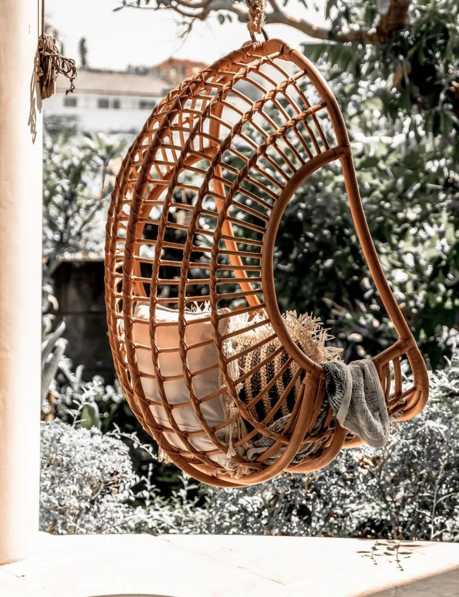 Hugo Rattan Hanging Chair in natural, cognac and brown rattan, handmade, eco-friendly, zero plastic, boho style, perfect for living room, terrace, or patio, stylish and comfortable swinging chair for modern or island-inspired interiors.
