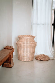 Handwoven Loomi Basket made from natural rattan, eco-friendly storage solution for bedrooms, bathrooms, living rooms, and laundry rooms, lightweight and durable, rustic and stylish home organisation accessory.