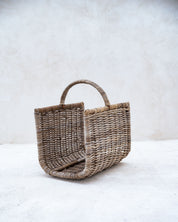 Woven basket with handles on a white background