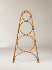Rattan decorative stand with circular design on a plain background