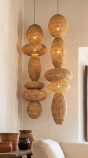 Woven pendant lights hanging in a room with neutral decor