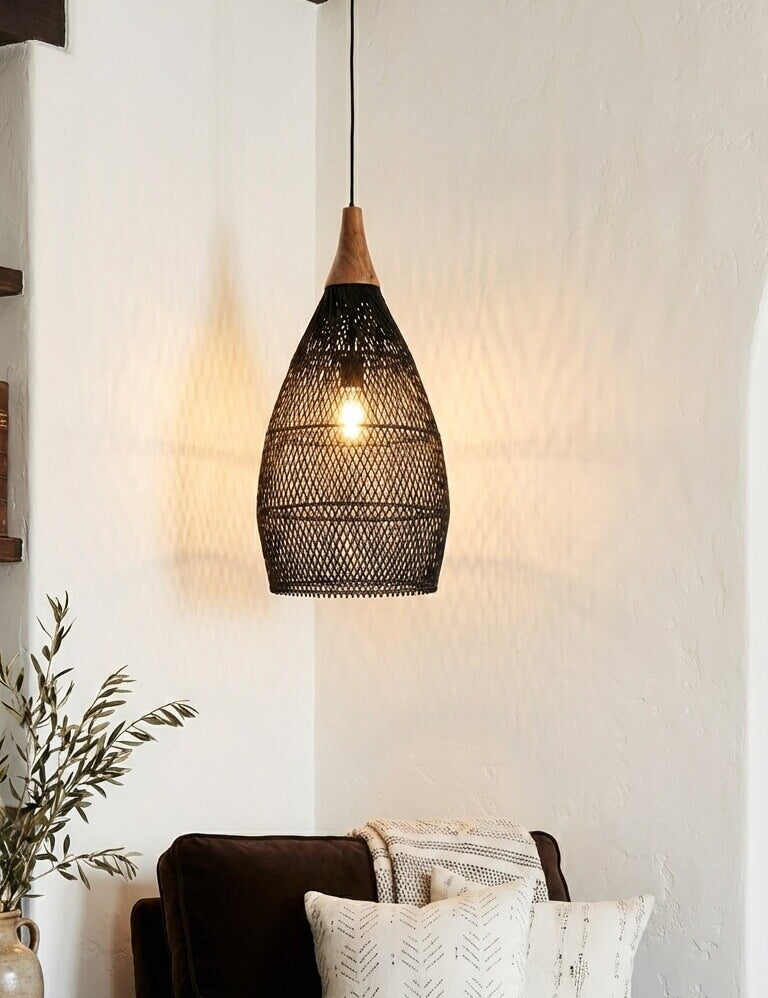 Woven pendant light hanging above a brown sofa with decorative pillows in a cozy living room.