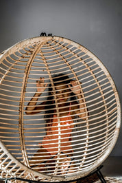 Hanging and standing rattan ball swing chair for adults and kids, available in single adult and junior sizes, handmade natural rattan, includes metal stand and rope, perfect for patio, garden, deck, or poolside, stylish boho, modern, and classic interior accessory.