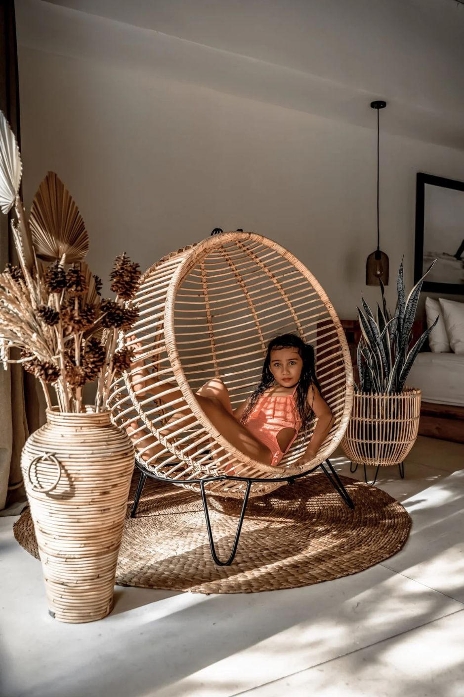Hanging and standing rattan ball swing chair for adults and kids, available in single adult and junior sizes, handmade natural rattan, includes metal stand and rope, perfect for patio, garden, deck, or poolside, stylish boho, modern, and classic interior accessory.