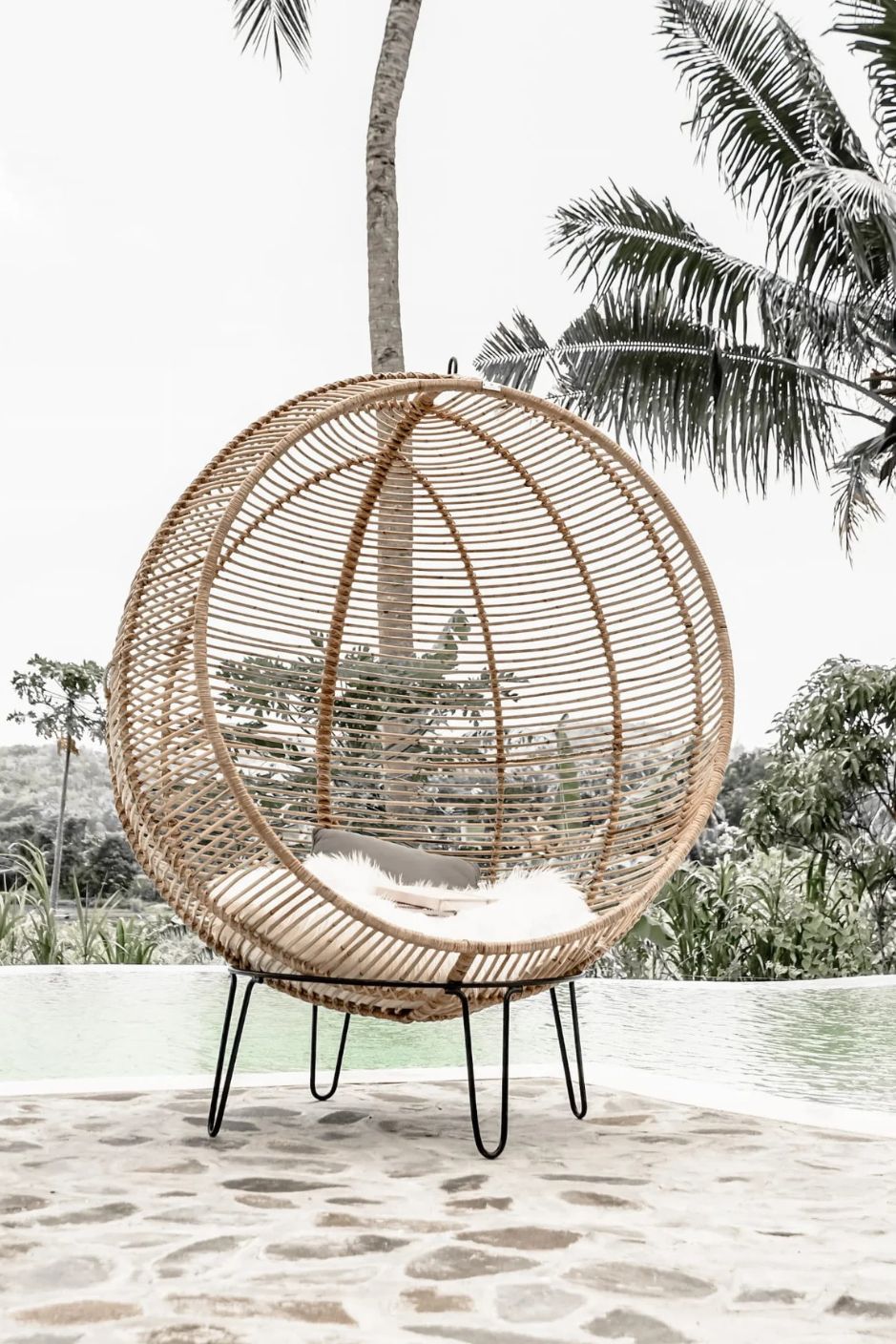 Hanging and standing rattan ball swing chair for adults and kids, available in single adult and junior sizes, handmade natural rattan, includes metal stand and rope, perfect for patio, garden, deck, or poolside, stylish boho, modern, and classic interior accessory.