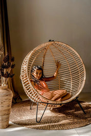 Hanging and standing rattan ball swing chair for adults and kids, available in single adult and junior sizes, handmade natural rattan, includes metal stand and rope, perfect for patio, garden, deck, or poolside, stylish boho, modern, and classic interior accessory.