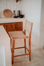 Handmade Harrison teak bar stool with woven synthetic seat and backrest, stylish and durable high chair for kitchen counters or bar tables, perfect for modern Australian interiors.