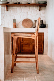 Handmade Harrison teak bar stool with woven synthetic seat and backrest, stylish and durable high chair for kitchen counters or bar tables, perfect for modern Australian interiors.