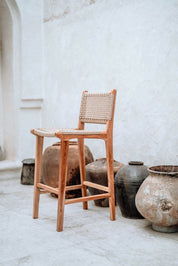 Handmade Harrison teak bar stool with woven synthetic seat and backrest, stylish and durable high chair for kitchen counters or bar tables, perfect for modern Australian interiors.