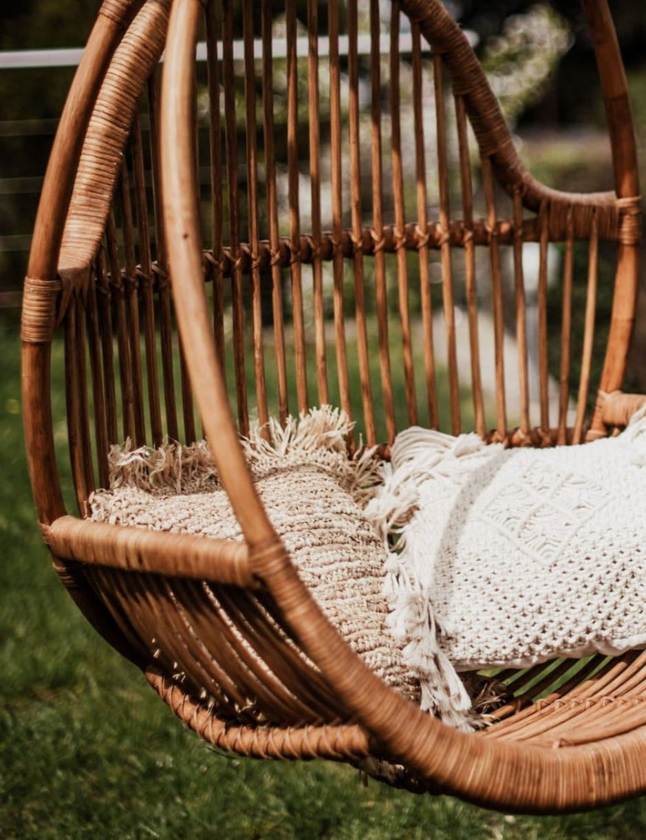 Henry single or double handmade durable cognac rattan hanging chair for indoor living rooms, covered terraces, patios, balconies, and outdoor gardens