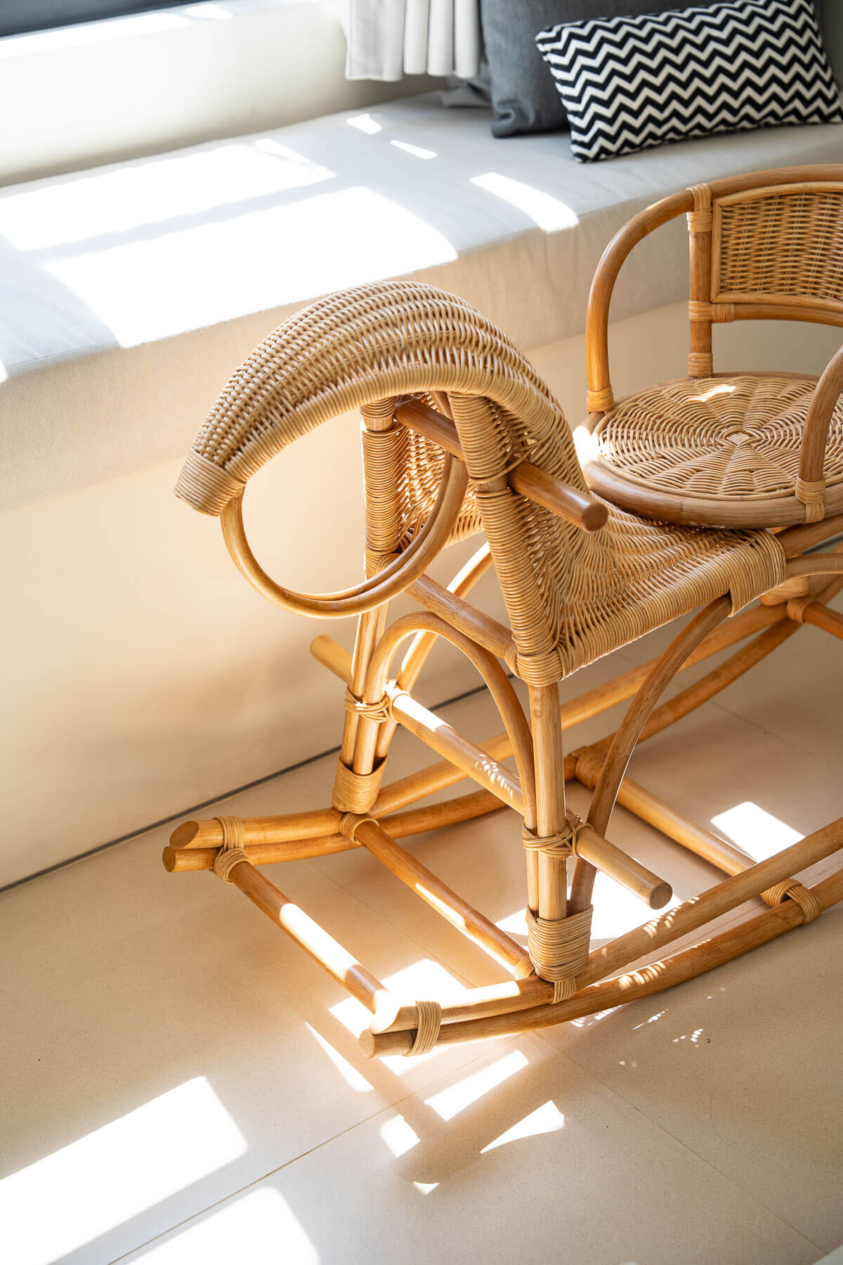 Wicker rocking chair on a light-colored floor with a neutral background
