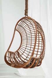 Side view of sculptural rattan lounge chair
