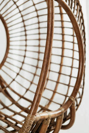 Hugo Rattan Hanging Chair in natural, cognac and brown rattan, handmade, eco-friendly, zero plastic, boho style, perfect for living room, terrace, or patio, stylish and comfortable swinging chair for modern or island-inspired interiors.