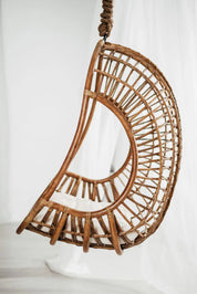 Hugo Rattan Hanging Chair in natural, cognac and brown rattan, handmade, eco-friendly, zero plastic, boho style, perfect for living room, terrace, or patio, stylish and comfortable swinging chair for modern or island-inspired interiors.
