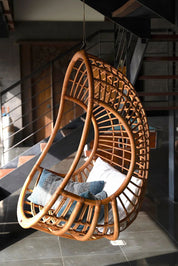 Hugo Rattan Hanging Chair in natural, cognac and brown rattan, handmade, eco-friendly, zero plastic, boho style, perfect for living room, terrace, or patio, stylish and comfortable swinging chair for modern or island-inspired interiors.