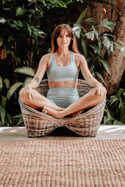 Indiana Yoga Chair handcrafted from sustainable rattan wood in natural and grey tones, ergonomic backrest and curved armrests for yoga, meditation, or relaxation, lightweight and eco-friendly indoor and outdoor seating