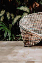 Indiana Yoga Chair handcrafted from sustainable rattan wood in natural and grey tones, ergonomic backrest and curved armrests for yoga, meditation, or relaxation, lightweight and eco-friendly indoor and outdoor seating