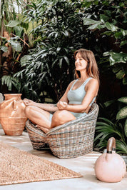 Indiana Yoga Chair handcrafted from sustainable rattan wood in natural and grey tones, ergonomic backrest and curved armrests for yoga, meditation
