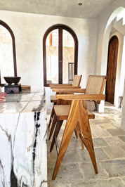 Joy Bar Stool made from durable teak wood with woven seat and backrest, ideal for kitchen islands, high countertops, and bar tables, handmade, stylish and comfortable seating for modern homes